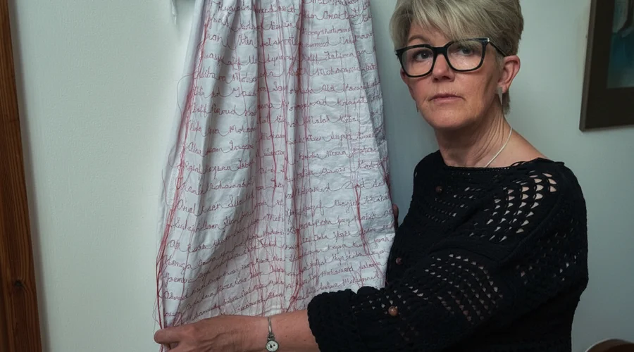 Welsh Artist Memorializes Infant Victims of Gaza Conflict Through Embroidered Gown